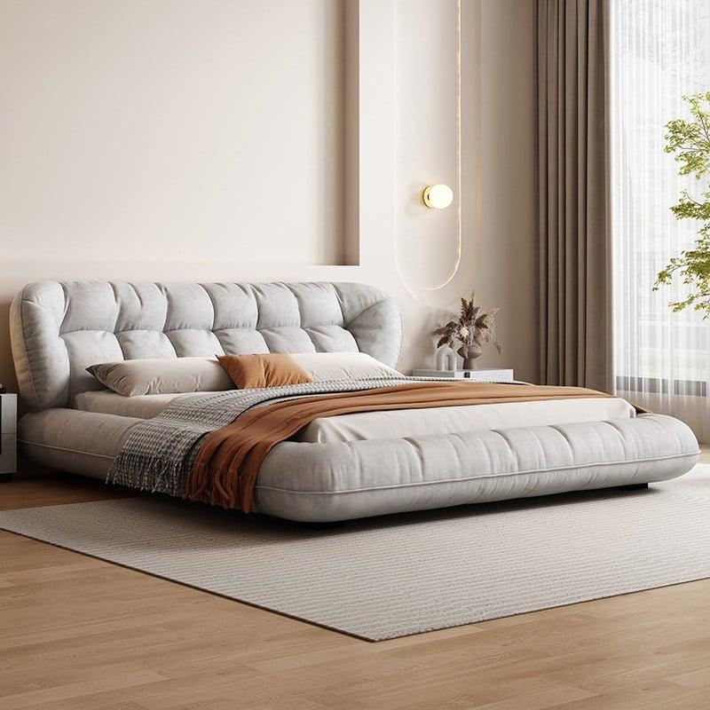 Soft upholstered tufted platform bed in neutral bedroom