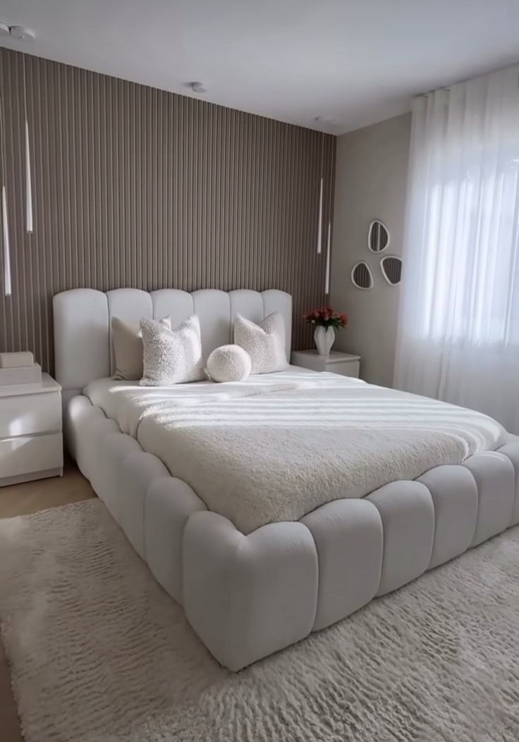 White upholstered bed with fluted feature wall